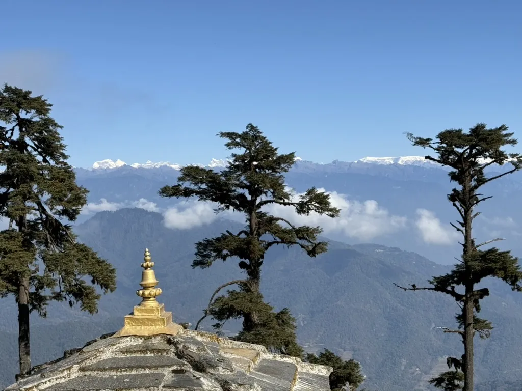 A golden chorten at Dochu La with the Himalaya beyond