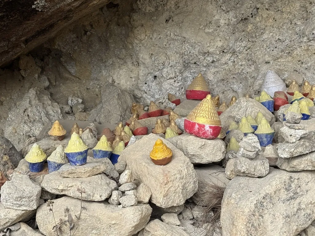 Votive clay stupas left in a rock shelter